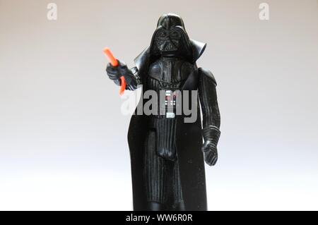 BERLIN - AUGUST 29, 2019: Vintage Star Wars Darth Vader Action Figure from Kenner with Lightsaber on white. Probably from 1978. Stock Photo