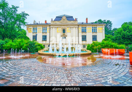 KRAKOW, POLAND - JUNE 13, 2018: The Palace of Fine Arts with the fountain and the small pond on Szczepanski Square in front of it, on June 13 in Krako Stock Photo