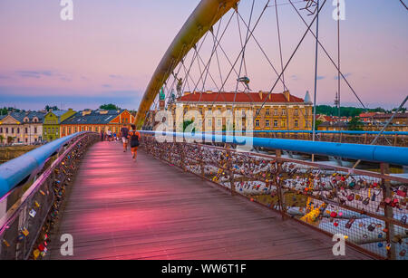 KRAKOW, POLAND - JUNE, 20, 2018: The modern Father Bernatek Footbridge with love padlocks on its railings is a very popular walking area between old r Stock Photo