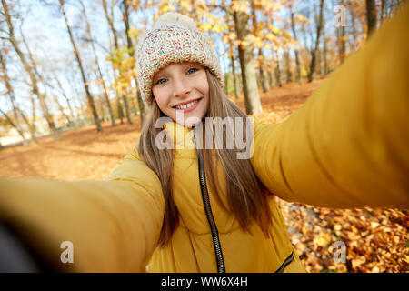 happy girl taking selfie at autumn park Stock Photo