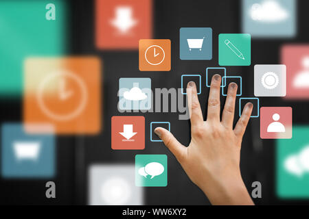 hand using interactive panel with app icons on it Stock Photo
