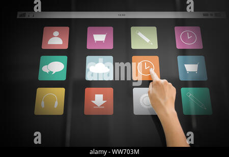 hand using interactive panel with app icons on it Stock Photo