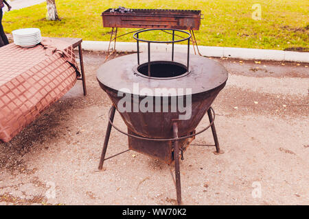 Dirty cast iron cooking grates on 6 burner outdoor gas grill Stock Photo