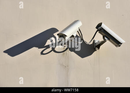 Modern CCTV security cameras on building wall outdoors Stock Photo