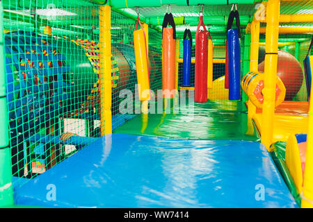 Modern playground indoor. Kids jungle in a play room. Round tunnel in children gym Stock Photo