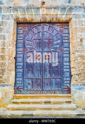 A typical Arab wooden door of a Mosque with the shape of Horseshoe arch. Stock Photo