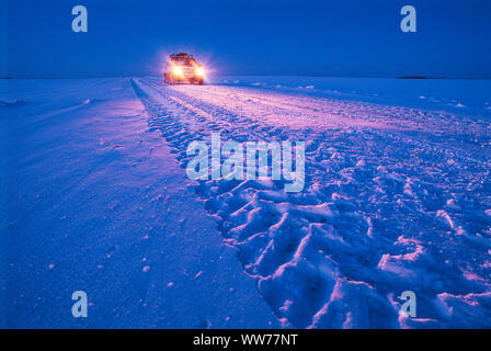 Car Driving on a Winter Road Stock Photo