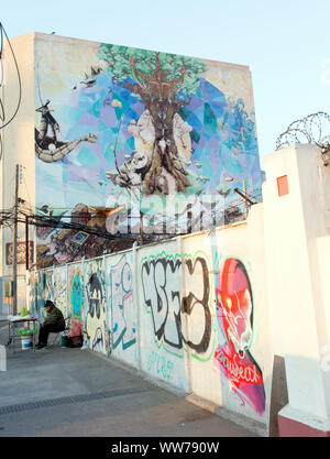 Valparaiso, Chile - August 09, 2019: a street view in Valparaiso with people selling street drink and murales Stock Photo