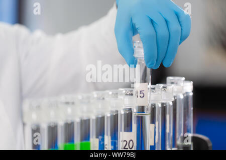 Scientist handling test tubes for water quality analysis at a treatment laboratory in Tampa, Florida. Stock Photo