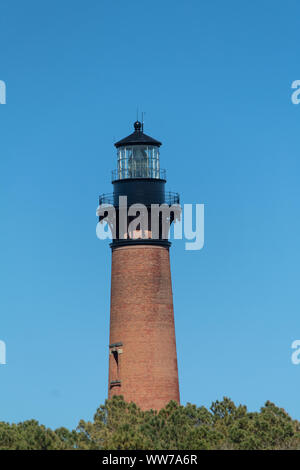 Telephoto shot of the Curituck Lighthouse, showcasing up close details. Trees twords the bottom Stock Photo