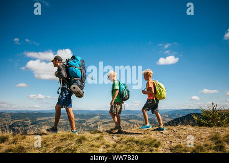 Family, dad and children go camping in the mountains Stock Photo