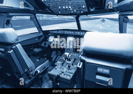 Cockpit of airliner simulator. Switches and dials visible in the background. Simulator cockpit. Stock Photo