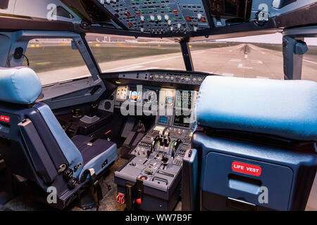 Cockpit of airliner simulator. Switches and dials visible in the background. Simulator cockpit. Stock Photo