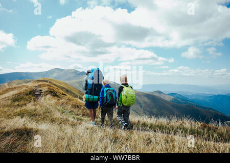 Family, dad and children go camping in the mountains Stock Photo
