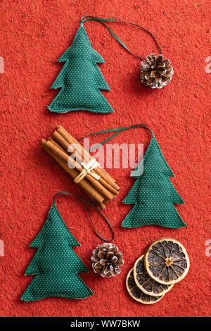 Christmas decoration with cones and Christmas tree made of fabric, cinnamon sticks Stock Photo