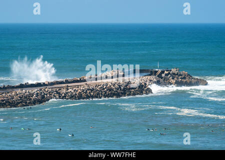 Morocco, Rabat, Kasbah Oudaias, view to the Atlantic Ocean, surfer in front of breakwater Stock Photo