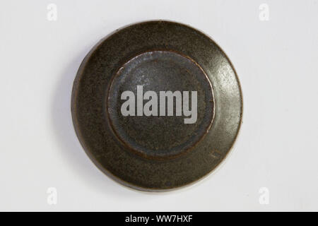 round clay probe with dark brown glossy glaze Stock Photo