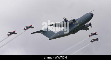 British Aerobatic display team, The Blades fly in a rare formation with an Airbus Defence and Space Atlas A400M Military Freight aircraft at the RIAT Stock Photo