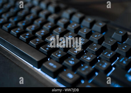 Gamer keyboard with colorful blue lights, modern gamer computer. Blue backlight, backlit on laptop or keyborad computer of gaming. Stock Photo
