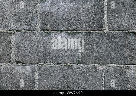 Grey brick solid wall pattern background close up view Stock Photo