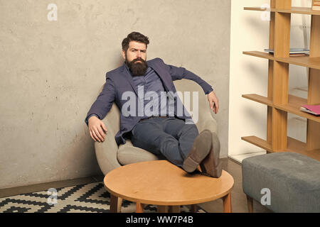 Tired businessman. Brutal businessman relaxing at workplace. Bearded businessman having break for rest in office. Businessman with beard and mustache Stock Photo