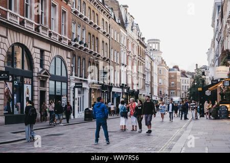 London, UK - August 31, 2019: People walking past shops on a street in Covent Garden, London, selective focus. Covent Garden is a famous tourist area Stock Photo