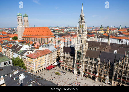 Munich, state capital of Bavaria, view from the church old Peter on the cCgurch of our Dear Lady (Frauenkirche), the neo-Gothic town hall and Marienplatz with Marian column. In the tower of the town hall there is a famous carillon from 16. cent. Stock Photo