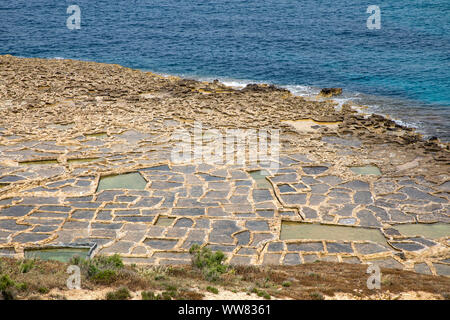 Gozo, neighbouring island of Malta, salt flats, salt pans for sea salt production, in the Xwejni Bay near Marsalforn, Stock Photo