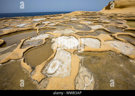 Gozo, neighbouring island of Malta, salt flats, salt pans for sea salt production, in the Xwejni Bay near Marsalforn, Stock Photo