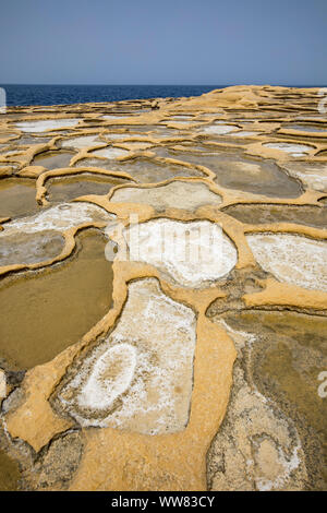 Gozo, neighbouring island of Malta, salt flats, salt pans for sea salt production, in the Xwejni Bay near Marsalforn, Stock Photo