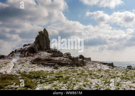 Carn Lêh, Old Town Bay, St. Mary's, Isles of Scilly, UK, under a rare fall of snow.  18th March 2018 Stock Photo