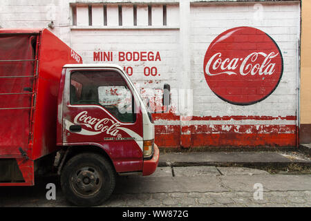 Coca Cola truck in front of wall with Coca Cola label Stock Photo