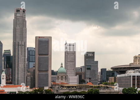 Singapore - March 20, 2019: Line of financial district skyscrapers from J.P.Morgan to Supreme Court buildings under dark gray cloudscape. Victoria the Stock Photo