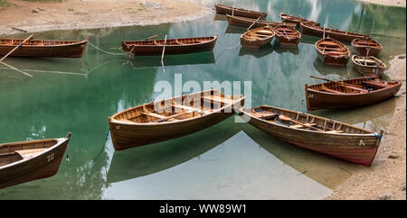 Autumn hike around the Pragser Wildsee in the Dolomites, Italy, wooden rowboats lying on the shore Stock Photo