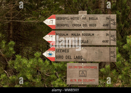 Autumn hike around the Pragser Wildsee in the Dolomites, Italy, wooden signpost, lake route Stock Photo