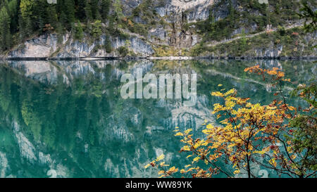 Autumn hike around the Pragser Wildsee in the Dolomites, Italy, autumn leaves and reflection in the water Stock Photo