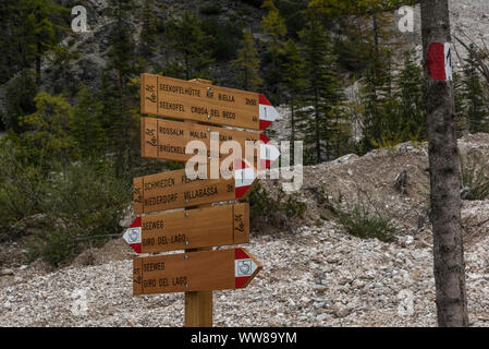 Autumn hike around the Pragser Wildsee in the Dolomites, Italy, wooden signpost, lake route Stock Photo