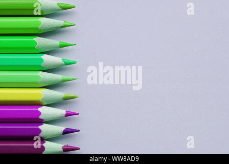 Bright and sharp contrast pencils on gray background with place for your text. Stock Photo