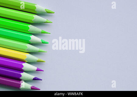 Bright and sharp contrast pencils on gray background with place for your text. Stock Photo