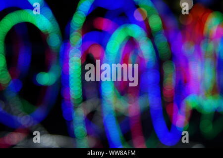Abstract background of blurred multicolored lines on dark background. Stock Photo