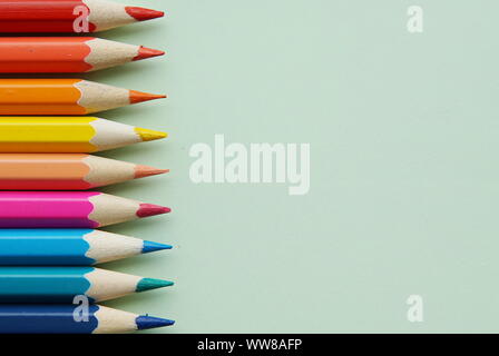Bright and sharp contrast pencils on gray background with place for your text. Stock Photo