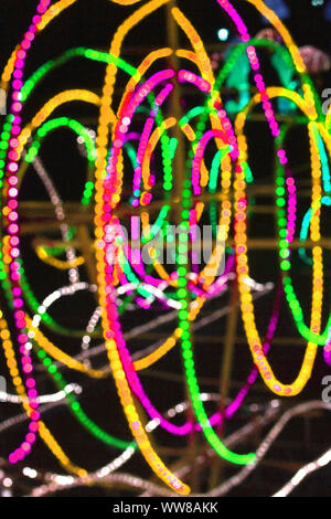 Abstract background of blurred multicolored lines on dark background. Vertical. Stock Photo