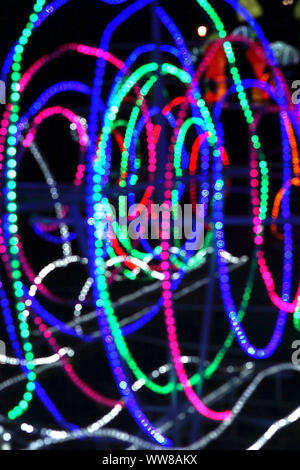 Abstract background of blurred multicolored lines on dark background. Vertical. Stock Photo