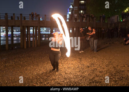 Oxo Tower Warf, London, UK. 13th Sept, 2019. Fire spinners meet for their once a month full moon fire spin at the Oxo Warf, on the banks of the river Thames. Penelope Barritt/Alamy Live News Stock Photo