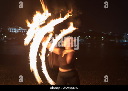 Oxo Tower Warf, London, UK. 13th Sept, 2019. Fire spinners meet for their once a month full moon fire spin at the Oxo Warf, on the banks of the river Thames. Penelope Barritt/Alamy Live News Stock Photo