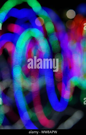 Abstract background of blurred multicolored lines on dark background. Vertical. Stock Photo