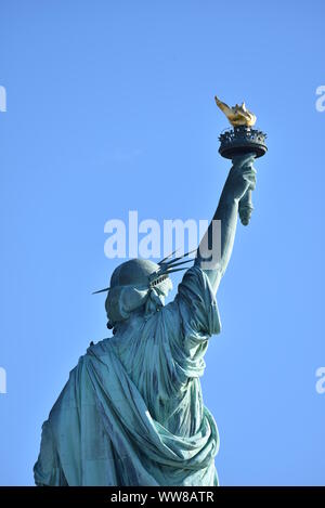 Back portrait of the Statue of Liberty on a sunny day, New York City, USA Stock Photo