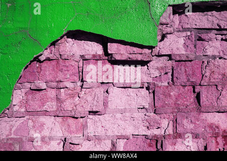 Crumbling painted green and purple brick wall texture. Backround. Stock Photo