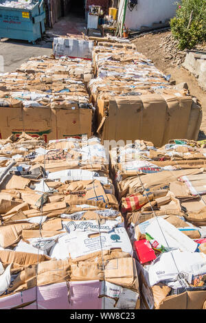 Bundles of cardboard for recycling on a loading dock. Stock Photo