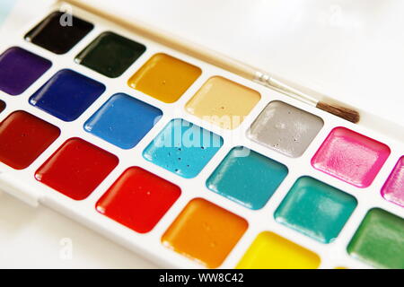 Tools of an watercolor artist-painter. White background, new beautiful paints and brashes. Close up. Stock Photo
